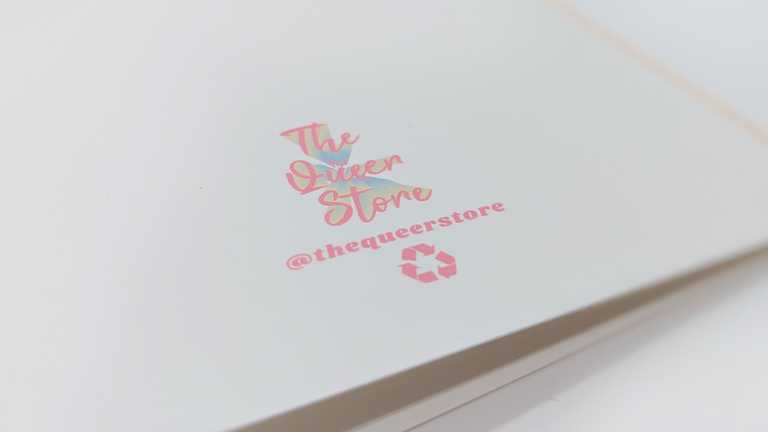 The Queer Store logo on the back of a card